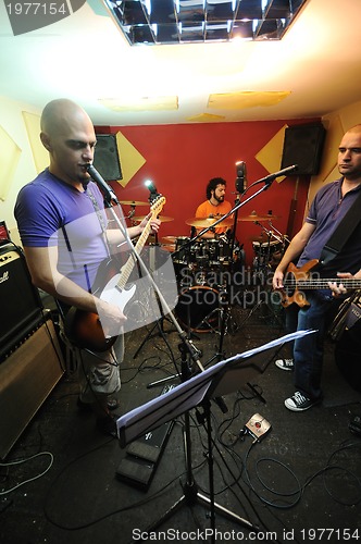 Image of music band have training in garage