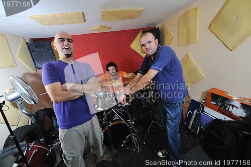 Image of music band have training in garage