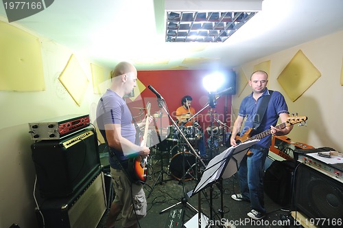 Image of music band have training in garage