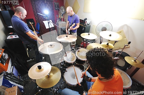 Image of music band have training in garage