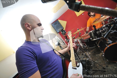 Image of music band have training in garage