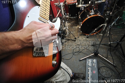 Image of music band have training in garage