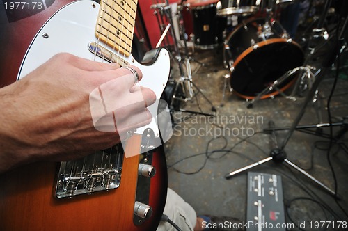 Image of music band have training in garage