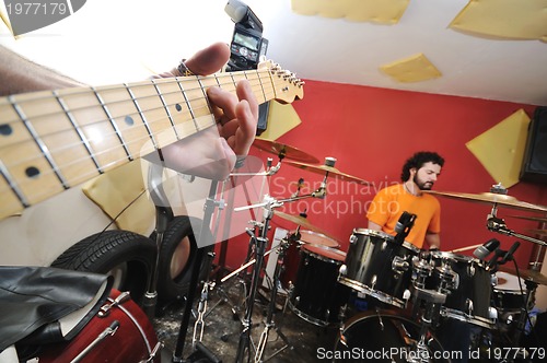 Image of music band have training in garage