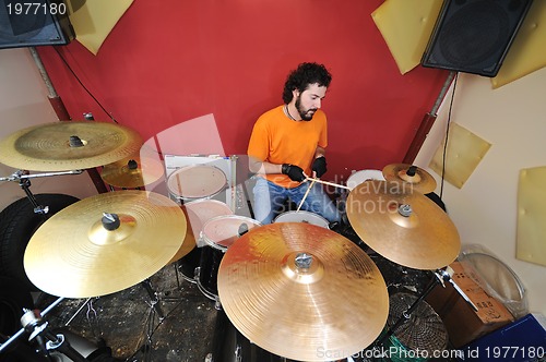 Image of music band have training in garage