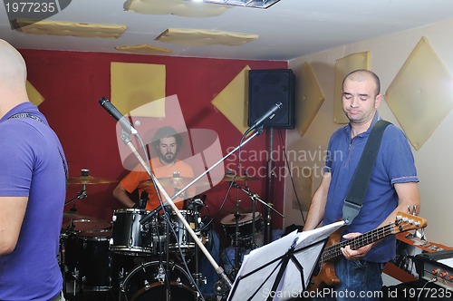 Image of music band have training in garage