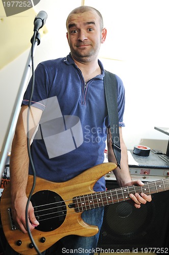 Image of music band have training in garage