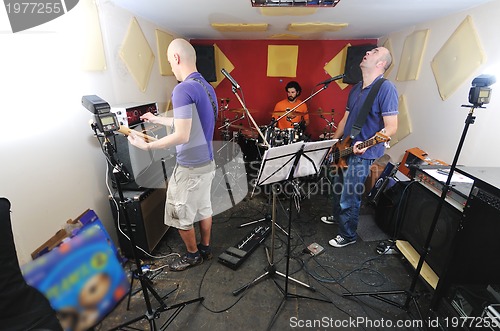 Image of music band have training in garage