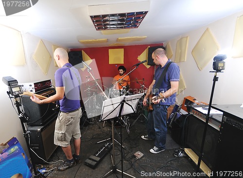 Image of music band have training in garage