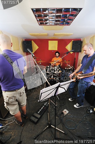 Image of music band have training in garage