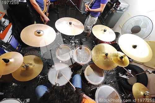 Image of music band have training in garage