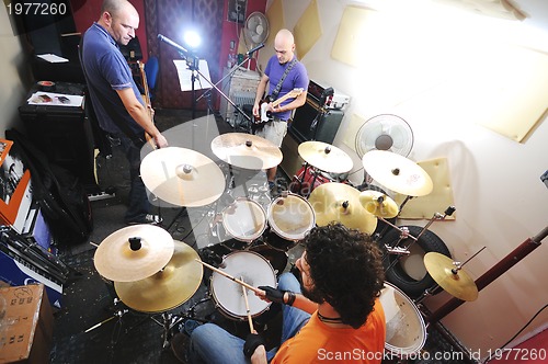 Image of music band have training in garage