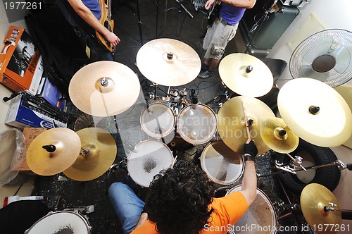 Image of music band have training in garage