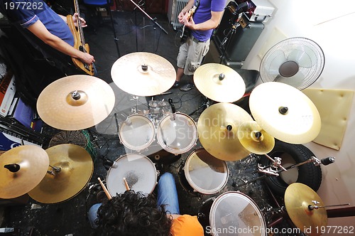 Image of music band have training in garage