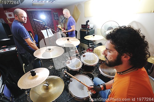 Image of music band have training in garage