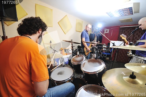 Image of music band have training in garage