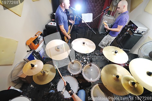 Image of music band have training in garage