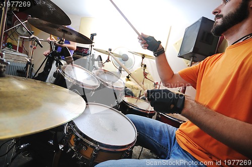 Image of music band have training in garage