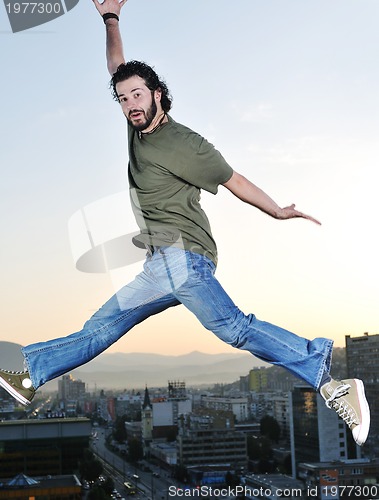 Image of man jump outdoor sunset