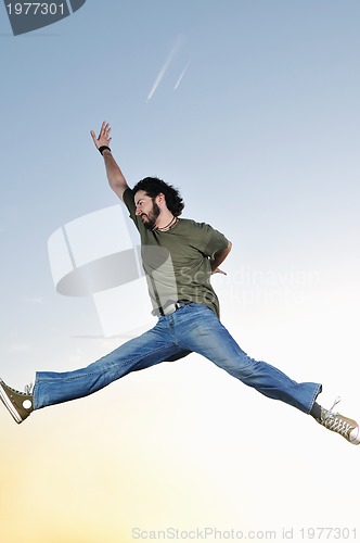 Image of man jump outdoor sunset