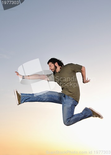 Image of man jump outdoor sunset