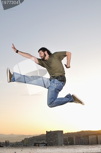 Image of man jump outdoor sunset