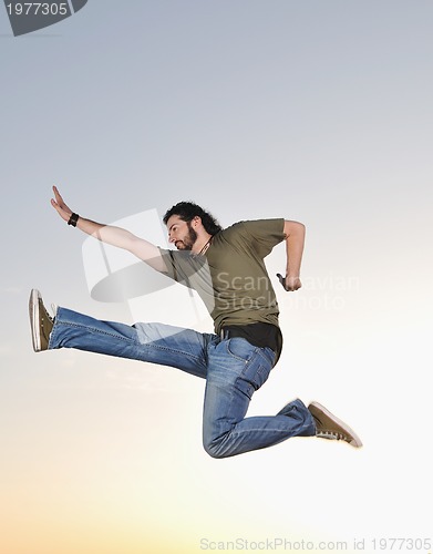 Image of man jump outdoor sunset