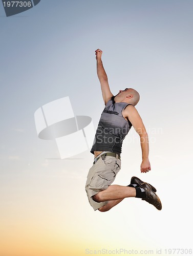 Image of man jump outdoor sunset