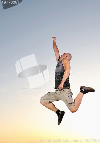 Image of man jump outdoor sunset