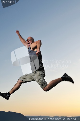 Image of man jump outdoor sunset