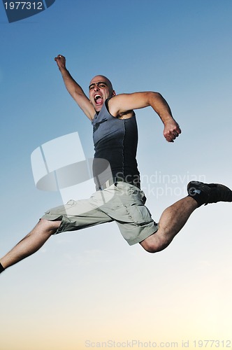 Image of man jump outdoor sunset