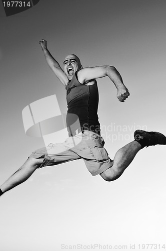 Image of man jump outdoor sunset