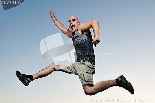 Image of man jump outdoor sunset