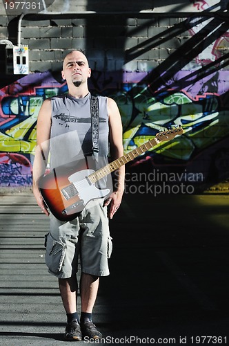 Image of music guitar player outdoor 