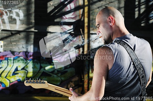 Image of music guitar player outdoor 