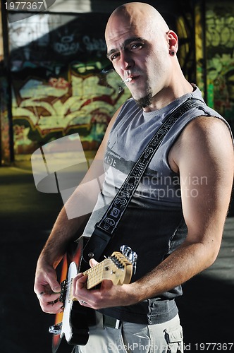 Image of music guitar player outdoor 