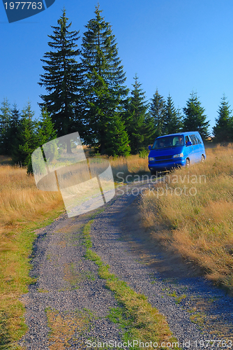 Image of blue van in nature