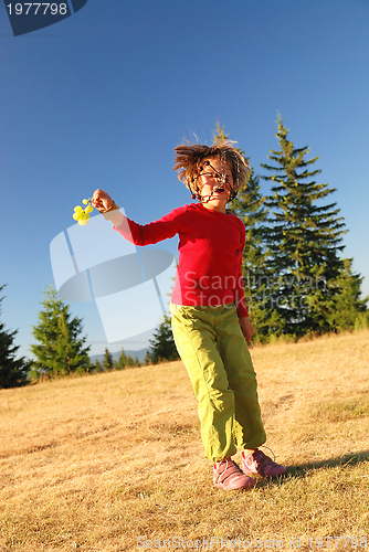 Image of happy child jumping in nature
