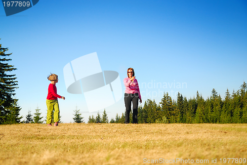 Image of mother and kids having fun outside