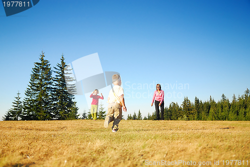 Image of mother and kids having fun outside