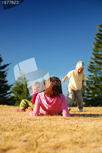 Image of mother and kids having fun outside