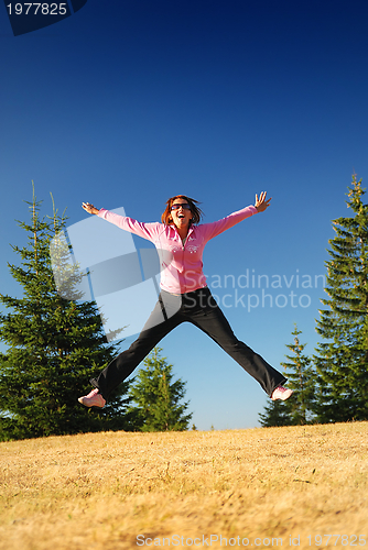 Image of pretty girl jumping in a air 