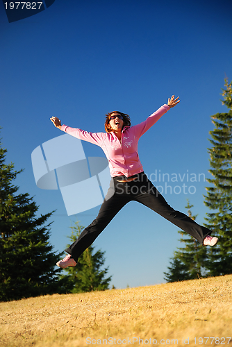 Image of pretty girl jumping in a air 