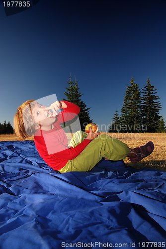 Image of the girl eating apple in nature