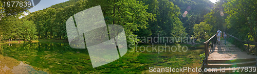 Image of young couple walking over wooden bridge