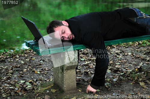 Image of sleeping businessman outdoor