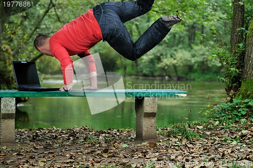 Image of young businessman jump outdoor