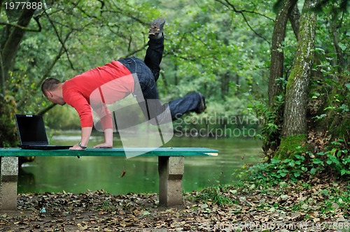 Image of young businessman jump outdoor