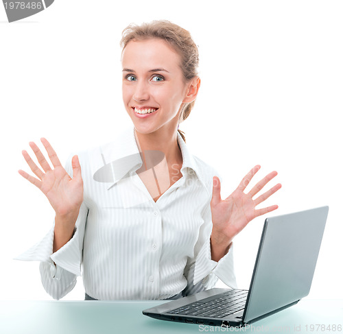 Image of friendly administrative assistant at the desk with a laptop