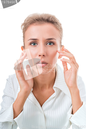 Image of Portrait of a woman, peering hard into the mirrorPortrait of a w